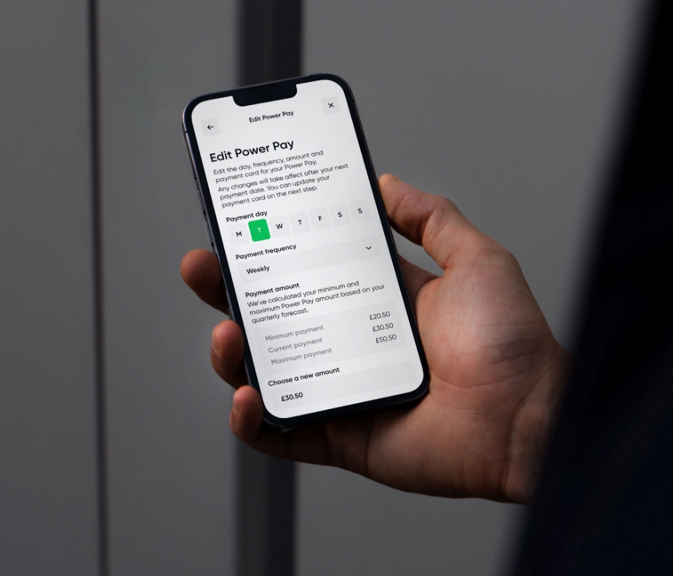 Person using My Utilita on a mobile phone, showing how customers can schedule their flexible energy payments with Power Pay.