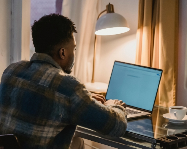 A man researching the electricity running costs of his household appliances using Utilita’s Power
                   Price List on a laptop